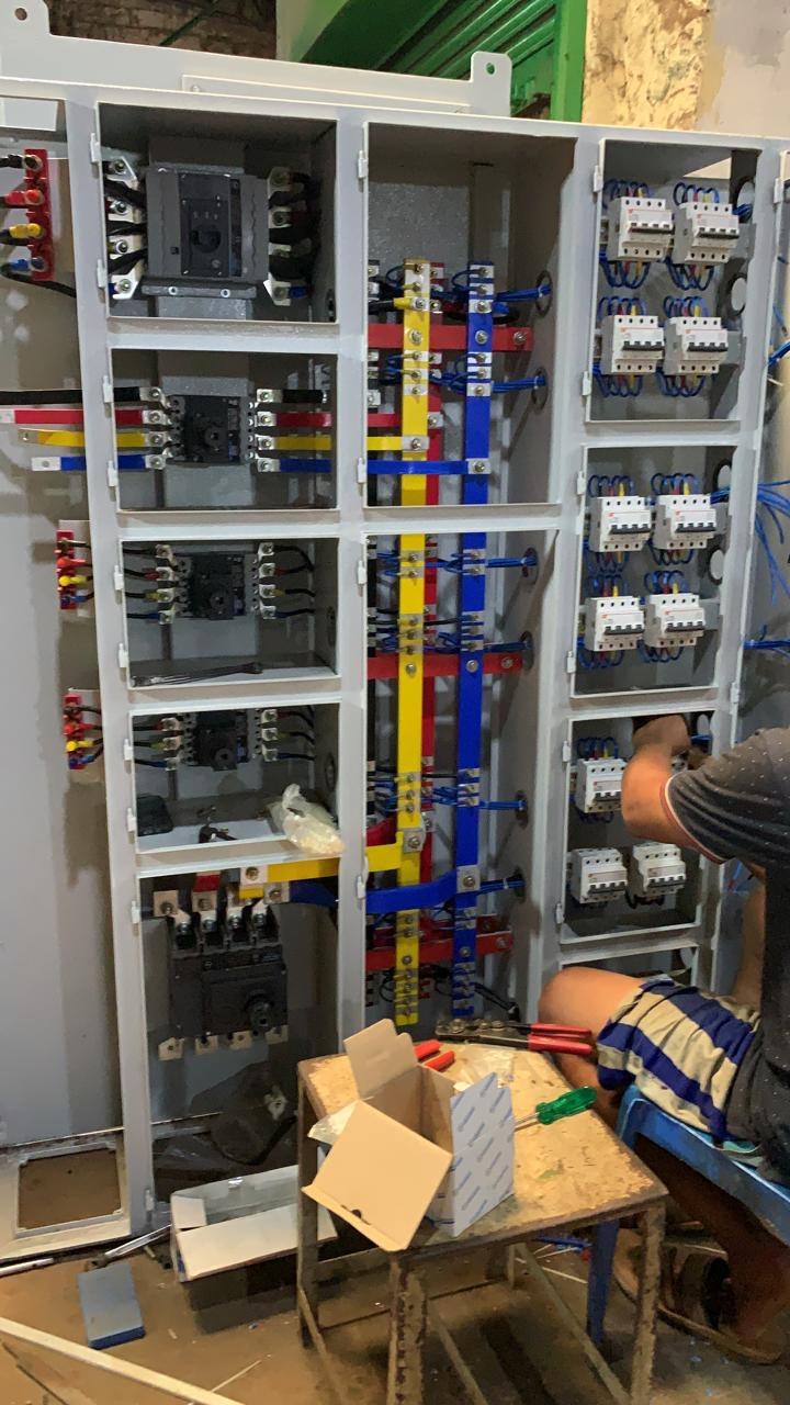 Colour-coded busbar wiring on an open panel at the AM Electricals workshop
